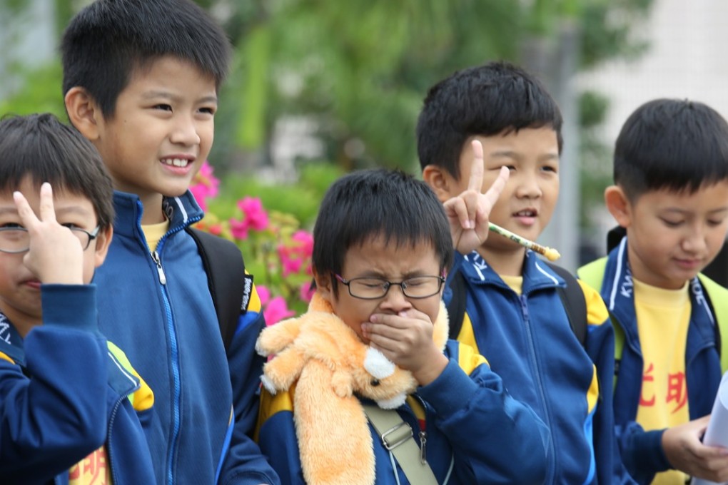 A primary student sneezes as temperatures drops, in Hong Kong’s Tsim Sha Tsui district on December 4th, 2015. Photo: SCMP/Nora Tam