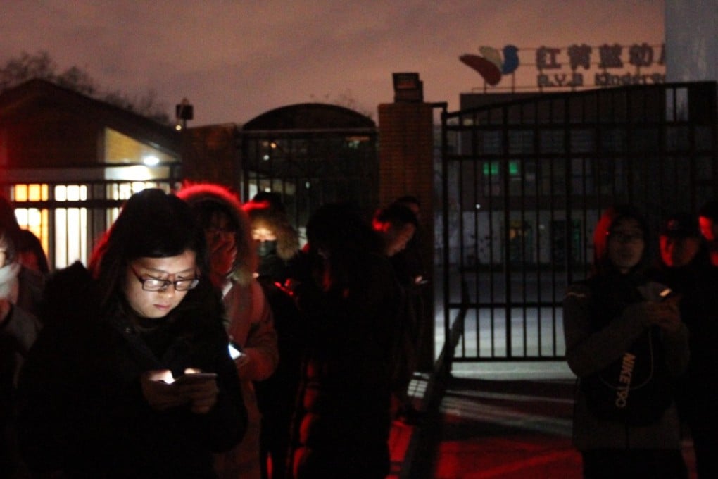 Media wait outside the RYB New World kindergarten in eastern Beijing on Thursday night. Photo: Simon Song