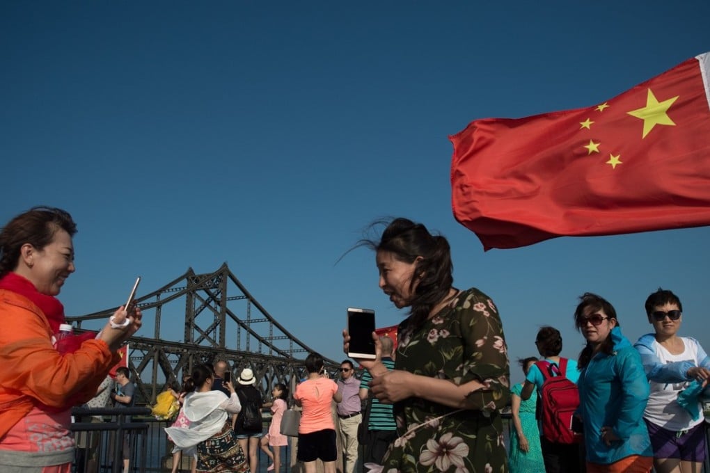 Chinese tourists pictured in Dandong, the main travel point into North Korea, earlier this year. Photo: AFP