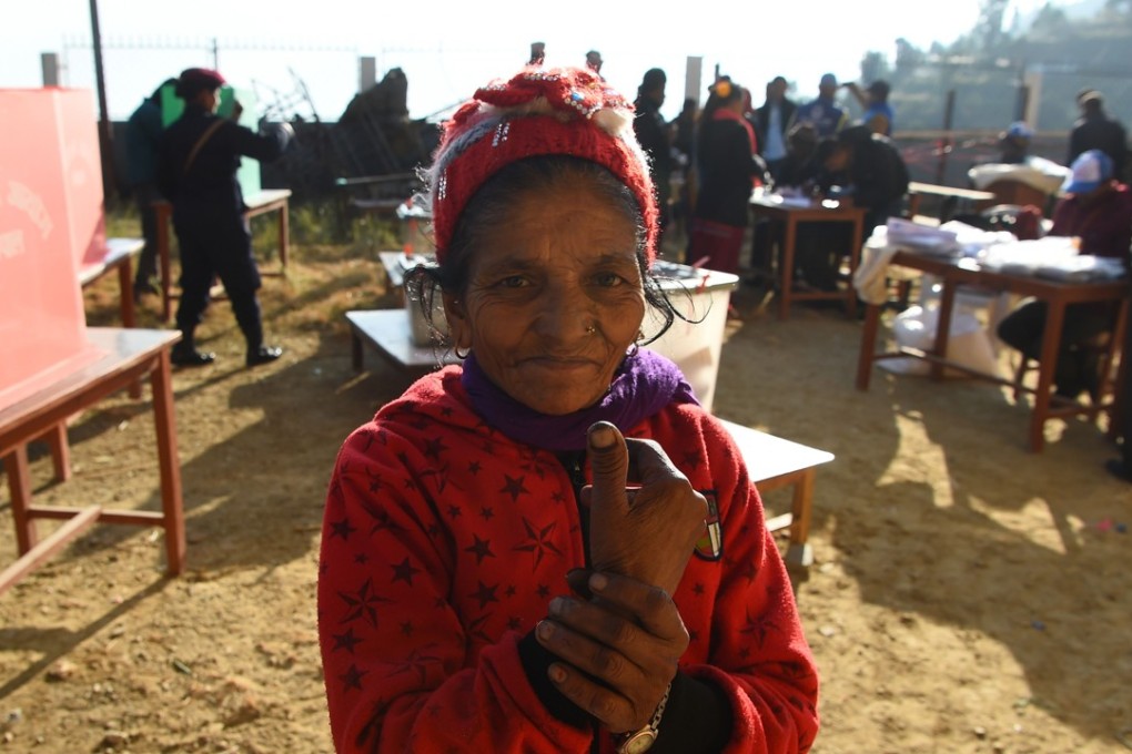 A Nepali voter shows her marked finger after casting a ballot at a polling station. Photo: AFP