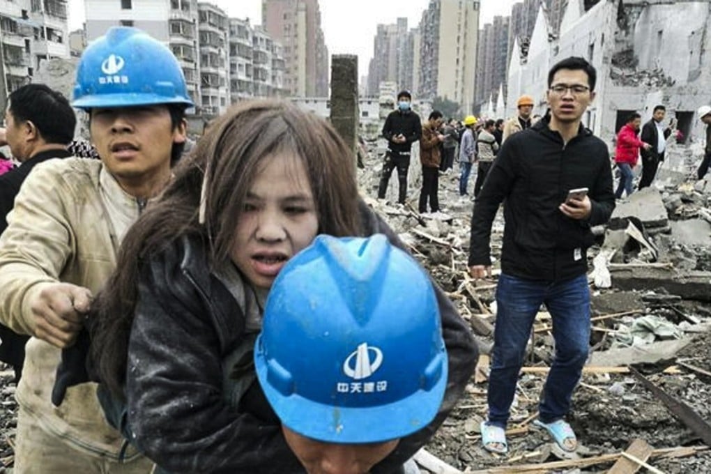 A woman is taken from the blast site in the Chinese port city of Ningbo, in eastern Zhejiang province, on Sunday morning. Photo: 163.com