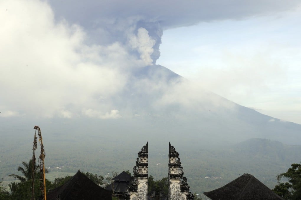 Huge columns of thick grey smoke have been released from Mount Agung in Bali, reaching more than 3km into the sky and forcing flights to be grounded. Photo: AP