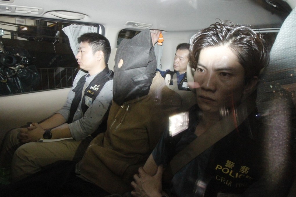 One of the seven people arrested is taken away by officers. Photo: Handout