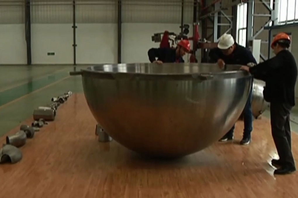 Engineers at Baoji Titanium Industry work on one of the halves of the submersible’s titanium sphere. Photo: CCTV
