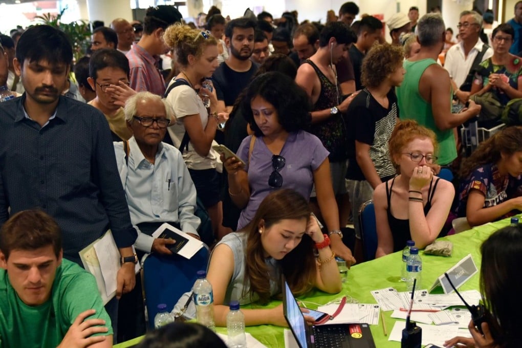 Passengers gather at Bali’s international airport after flights were cancelled due to the threat of an eruption at Mount Agung. Photo: AFP