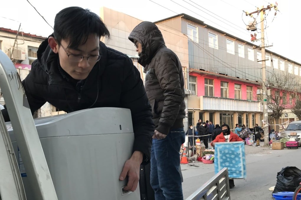 People move out of a residential building on the outskirts of Beijing close to where a fire in a two-storey structure killed 19 people this month. Photo: Simon Song