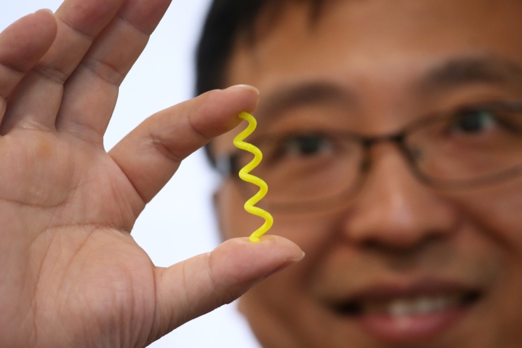 Chinese University’s Zhang Li showing an enlarged model of spirulina algae, the main material for the microrobot. Photo: David Wong