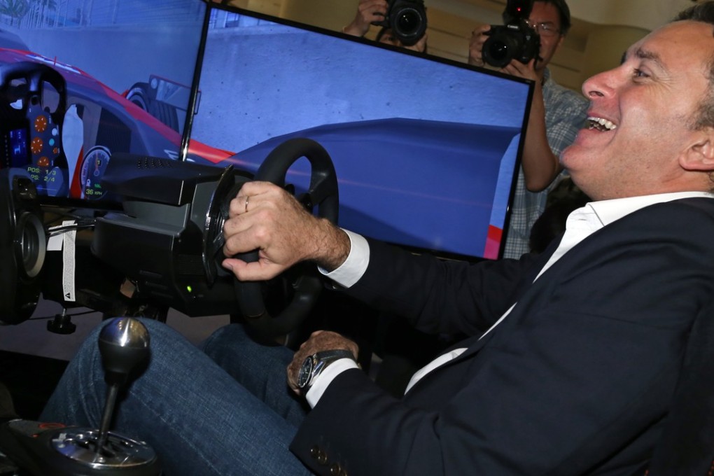 Alejandro Agag, chief executive of Formula E, takes a virtual spin in a simulator. Photo: Dickson Lee