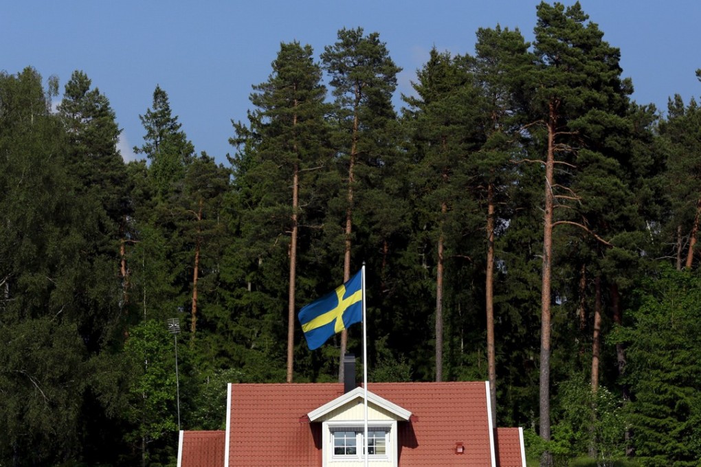 The Swedish national flag flies in front of a house near the town of Sodertalje, south west of Stockholm in Sweden. Photo: Reuters
