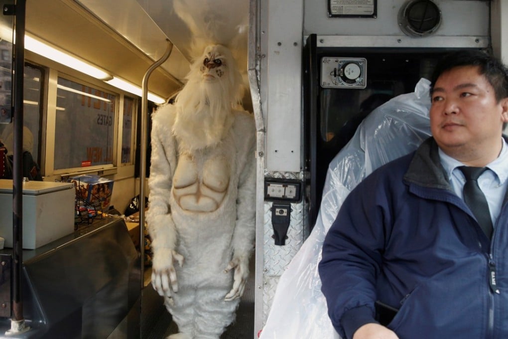 A tour bus driver watches as an actor dressed as a yeti walks on his bus during a promotional event for Travel Channel's Expedition Unknown: Hunt for the yeti in Manhattan on October 4, 2016. Photo: Reuters