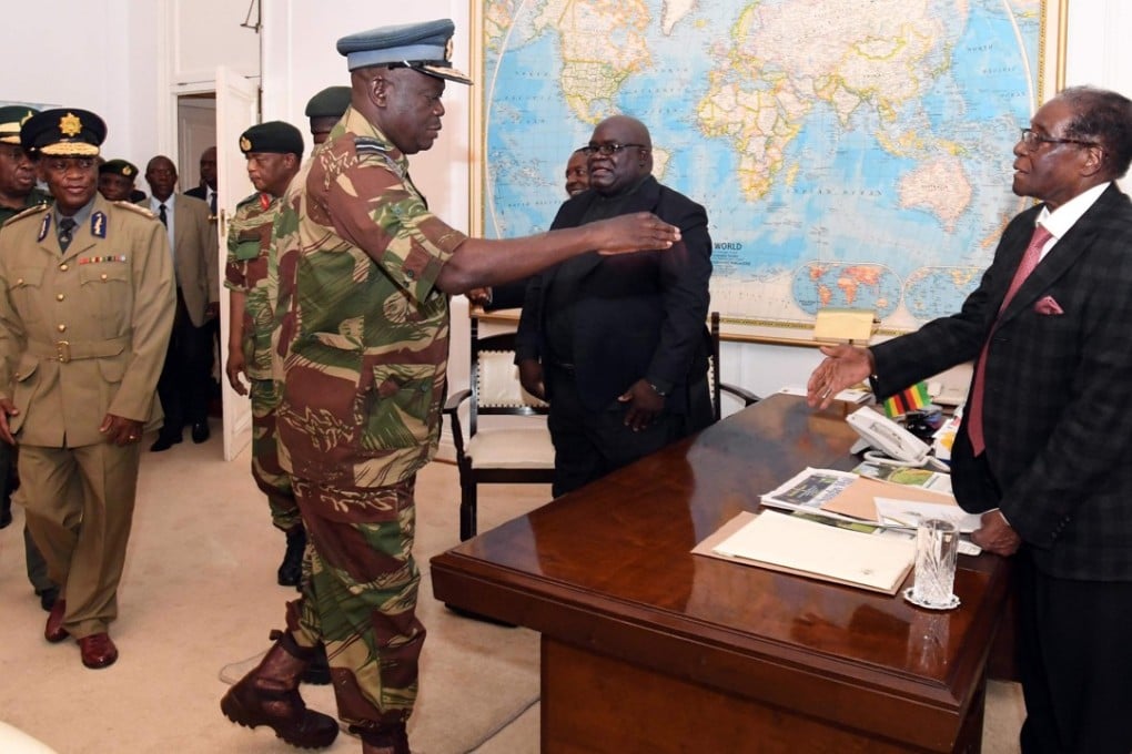 Zimbabwe’s Robert Mugabe (right), in Harare, during a November 19 meeting with army chiefs who have seized power. Picture: AFP