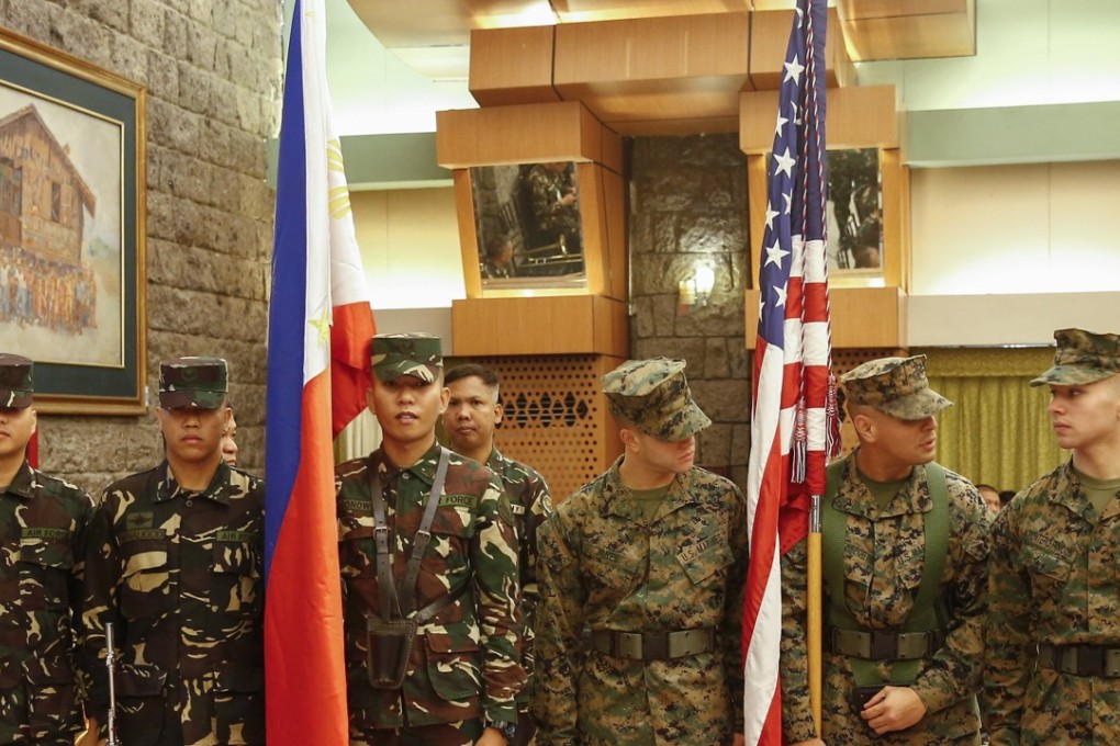 Philippine (L) and United States (R) troops with their respective country flags prepare for opening ceremonies of the Philippines-United States annual military exercises at Philippine armed forces headquarters in Quezon City, east of Manila. Photo: EPA
