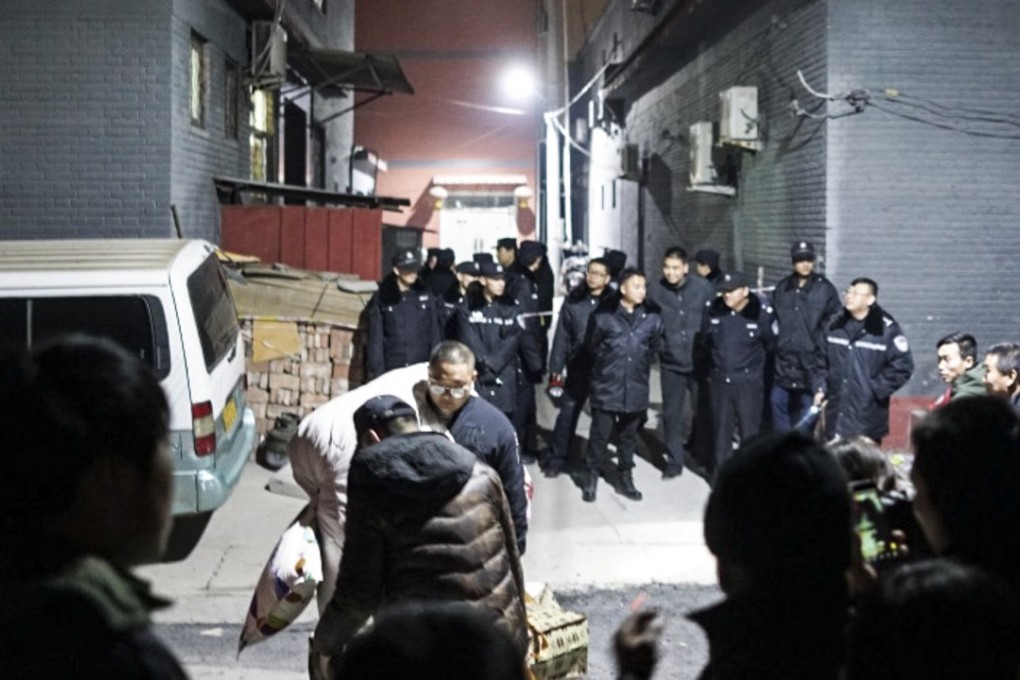Police mount a night raid near the Beijing airport, evicting occupants from their homes as part of a safety crackdown. Photo: Handout