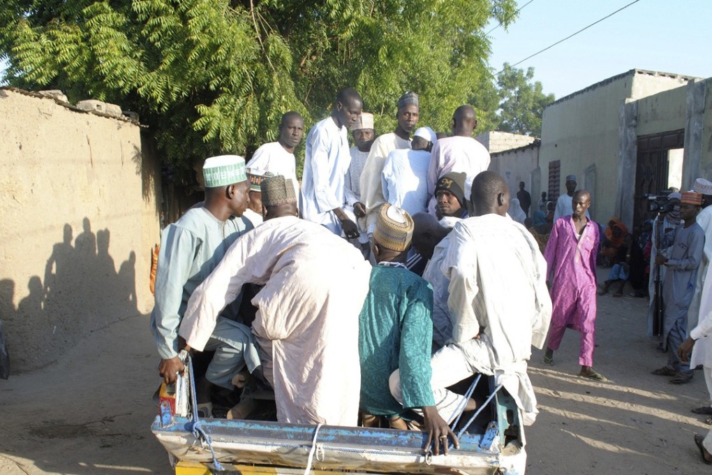 People transport a body of a suicide attack victim for funeral in Maiduguri, Nigeria, in an attack blamed on the group Boko Haram. The home of the group’s founder is supposed to be turned into a museum. Photo: AP
