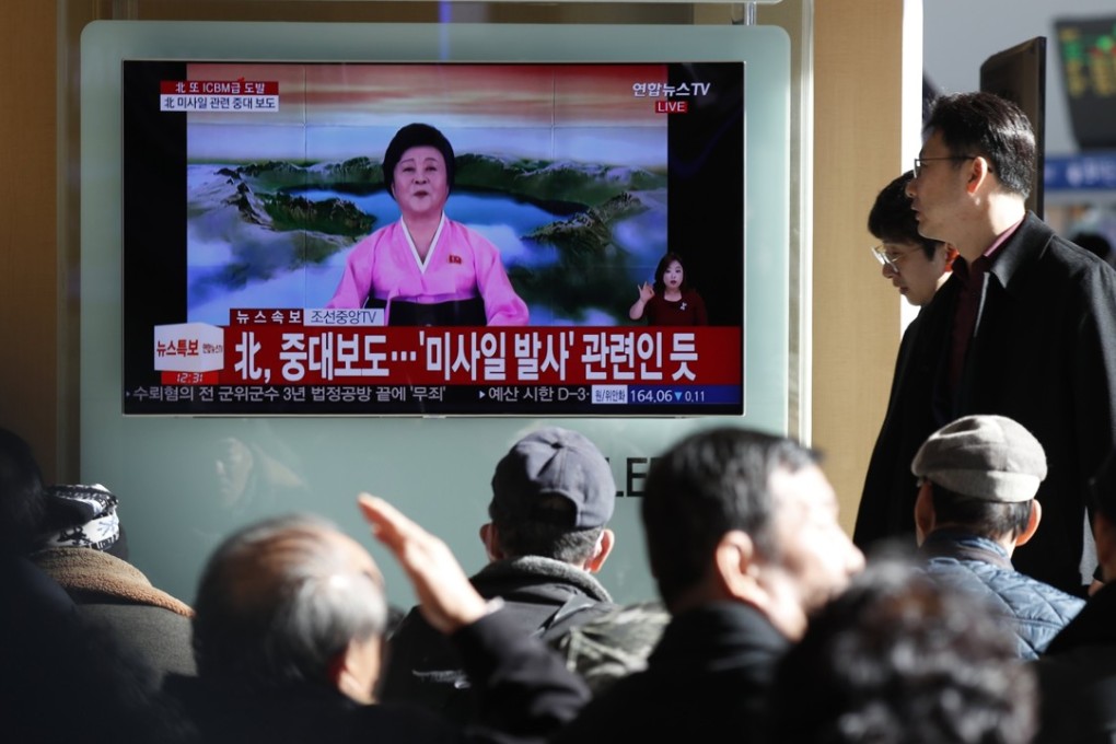 South Koreans watch a live TV report showing North Korea’s missile test announcement at a station in Seoul on Wednesday. Photo: EPA