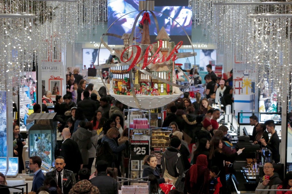 People shop in Macy's Herald Square during early opening for the Black Friday sales in Manhattan, New York. US consumer confidence hit a 17-year high. Photo: Reuters