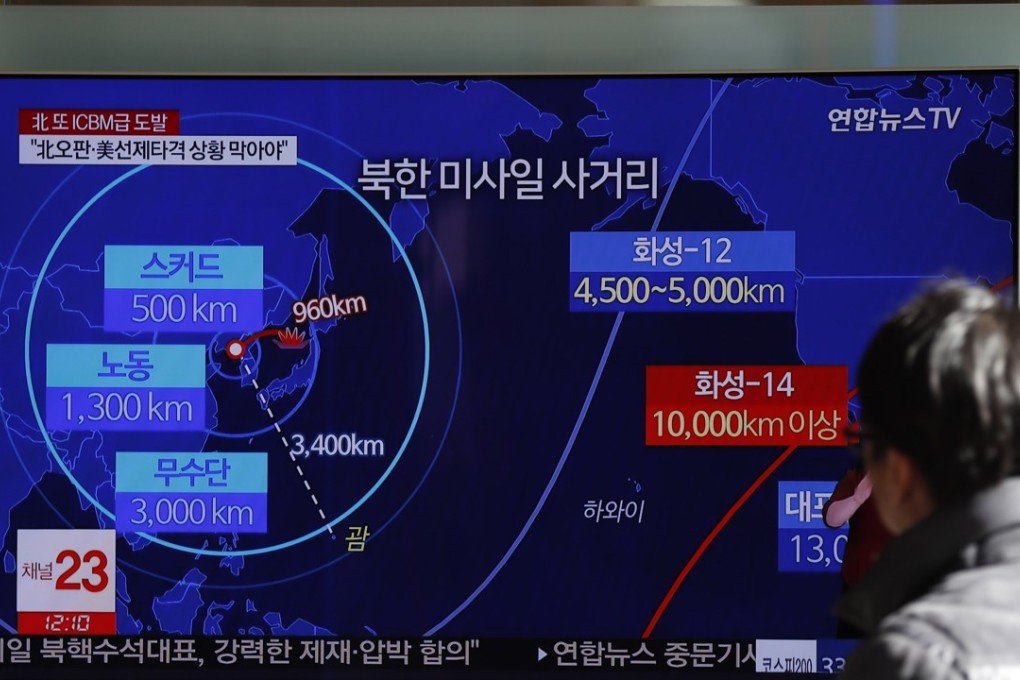 South Koreans watch a television displaying news broadcasts reporting on North Korea's latest ballistic missile launch, at a station in Seoul. Photo: EPA