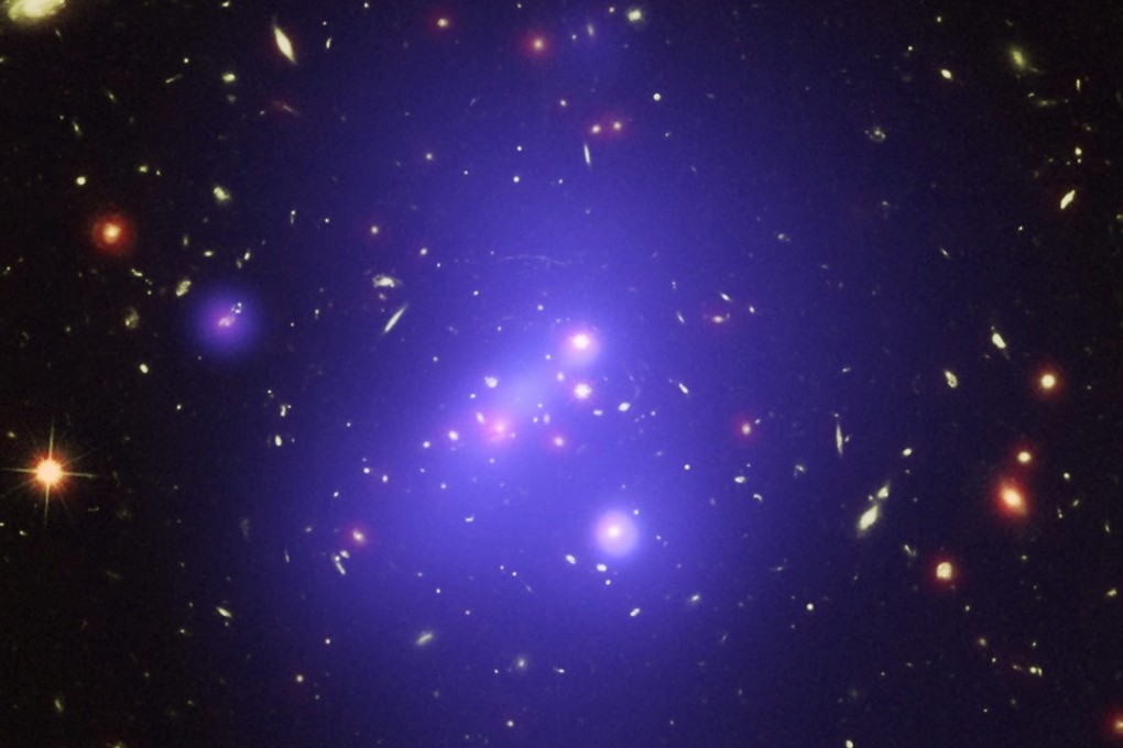 A file picture released by Nasa of a galaxy cluster 10 billion light years from Earth. Photo: EPA