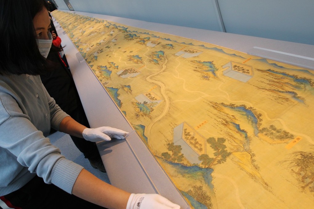A member of staff opens the map for viewing. Photo: Simon Song
