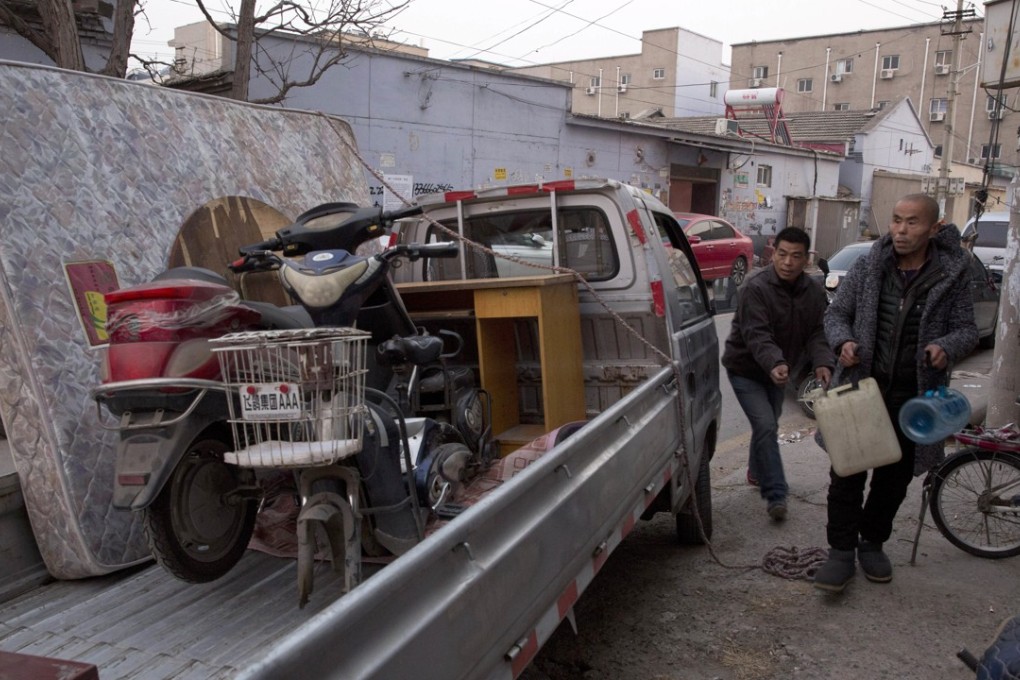 Migrant workers pack their belongings onto a truck as they leave from the outskirts of Beijing on Monday. The authorities in the capital have been evicting domestic migrant workers in droves, triggering a public outcry over the harsh treatment of people the city depends on to build their skyscrapers, care for their children and take on other low paid work. Photo: Associated Press