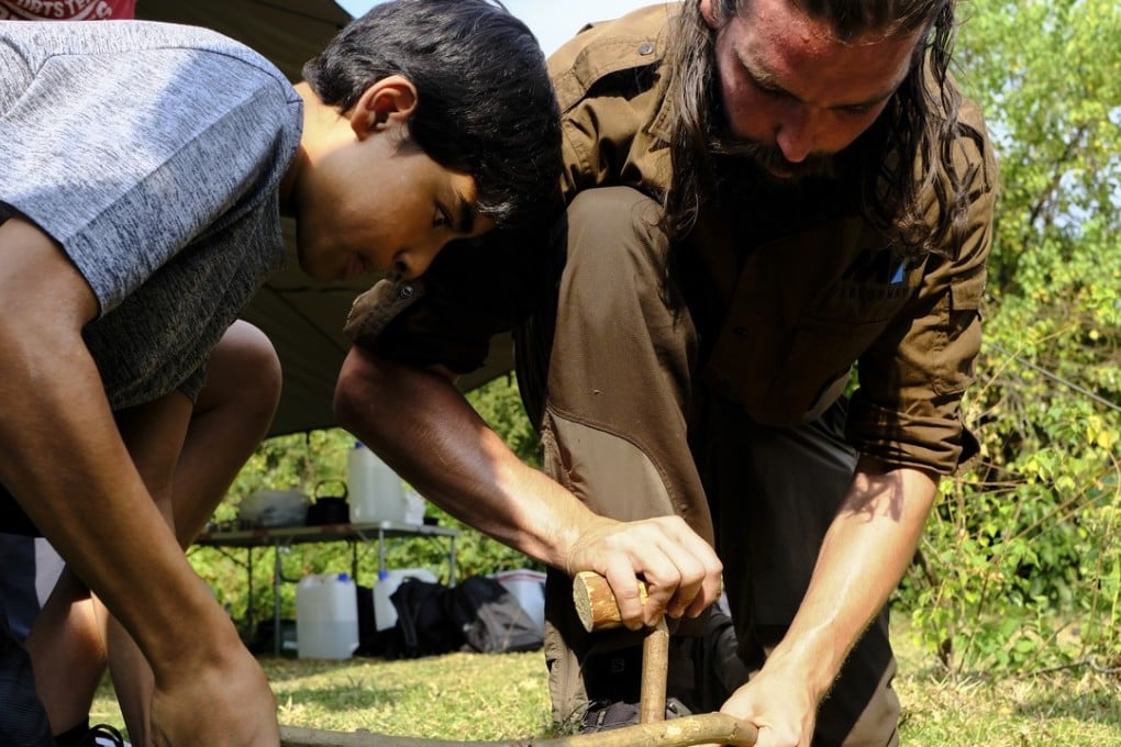 Instructor Paul McCusker shows how to light a fire on Tap Mun Island, Hong Kong. Photo: James Wendlinger
