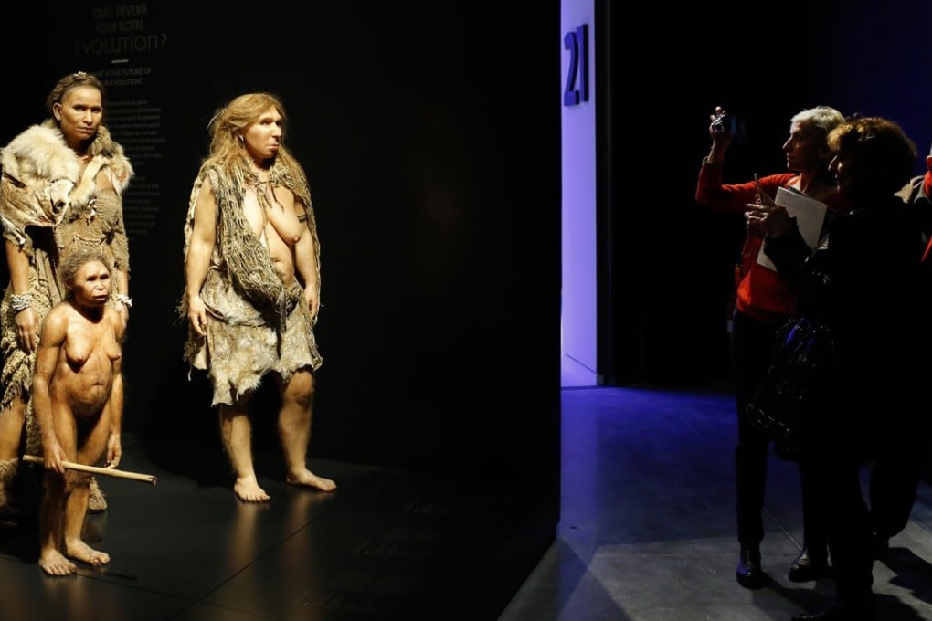 Visitors take pictures of models representing Flores, prehistoric human and Neanderthal women in the Musee des Confluences anthropology museum in Lyon, central France. Photo: AP
