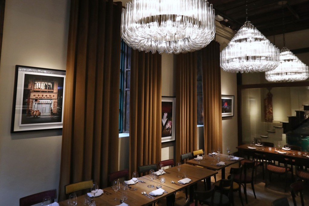 Chandeliers hang from the high beamed ceiling at Italian restaurant La Piola in Wan Chai. Photo: Nora Tam