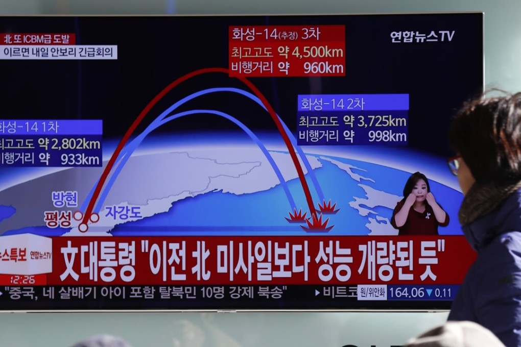 South Koreans watch a news broadcast reporting on North Korea's latest ballistic missile launch, at a station in Seoul. The long range missile crashed into Japan's exclusive economic zone after reaching a record 4,000km altitude. Photo: EPA