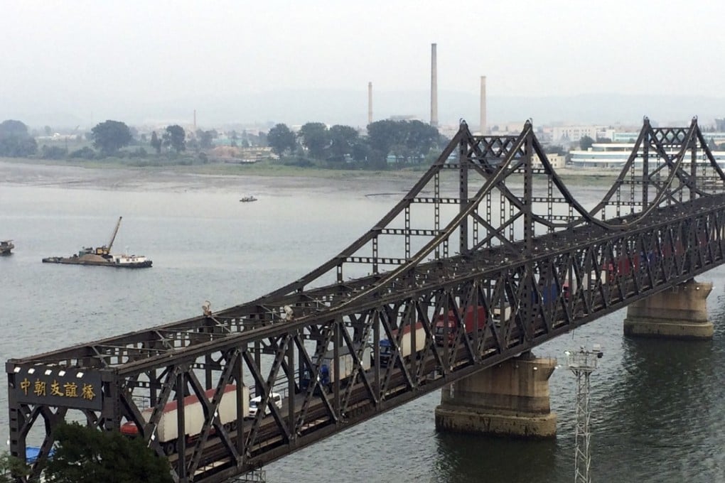 Trucks laden with goods crossing a bridge between China and North Korea in Dandong in September. Increasingly strict sanctions have been introduced by the UN against Pyongyang. Photo: Associated Press
