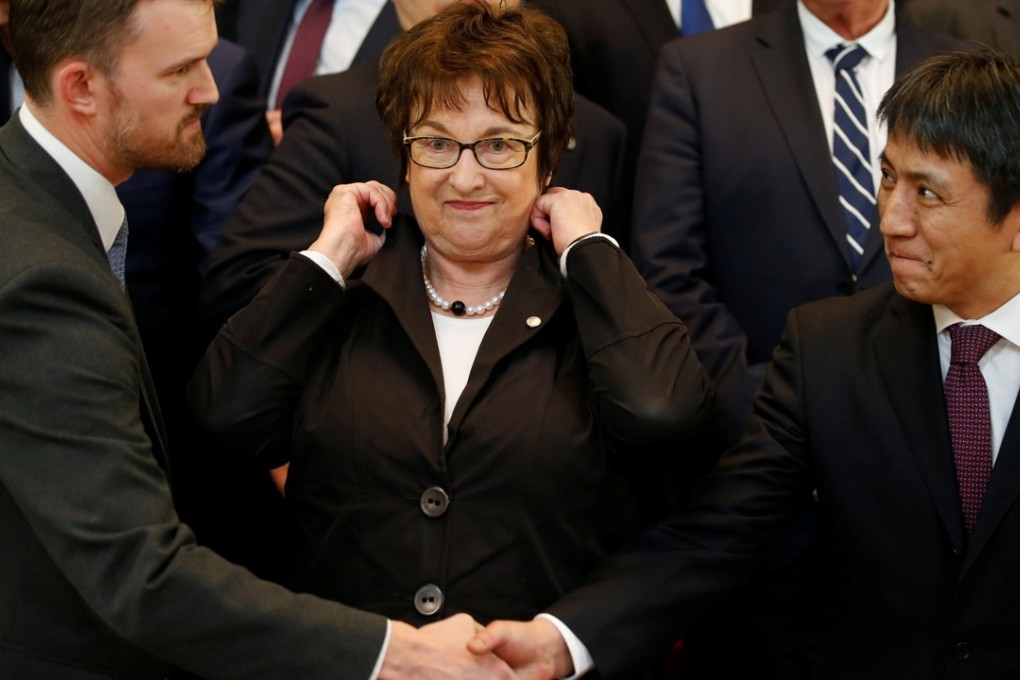 Assistant Minister of Commerce of China Li Chenggang and Chief of Staff to the Trade Representative of the United States Jamieson Greer shake hands in front of German Economy and Energy Minister Brigitte Zypries during the G20 forum on steel overcapacity where the two countries exchanged barbs over the issue. Photo: Reuters