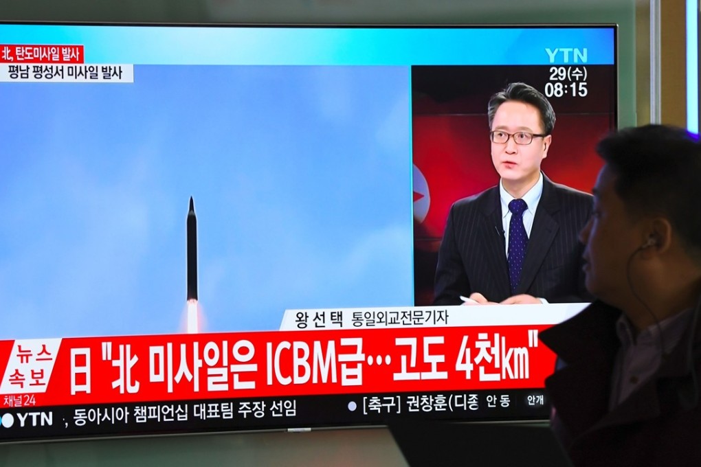 A man walks past a television screen showing North Korea’s latest missile launch, at a railway station in Seoul on Wednesday. Photo: AFP