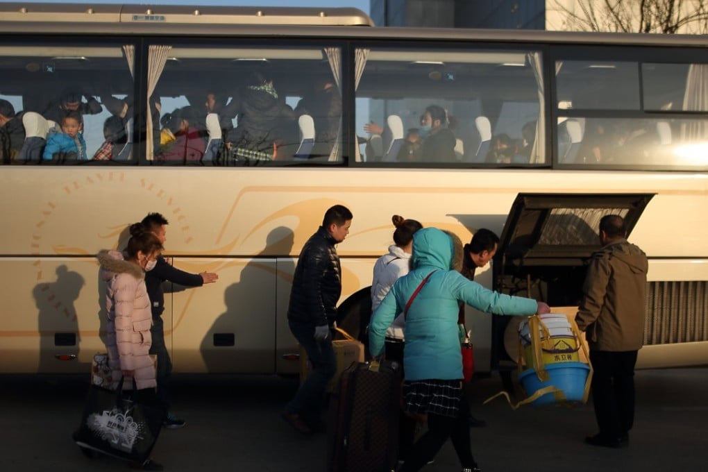 Migrant workers get on a long-distance bus to leave Beijing on November 24, after their factory was closed by the authorities in a crackdown on migrant worker communities. They will move to Changshu in Zhejiang, where the factory will be relocated. Photo: EPA-EFE