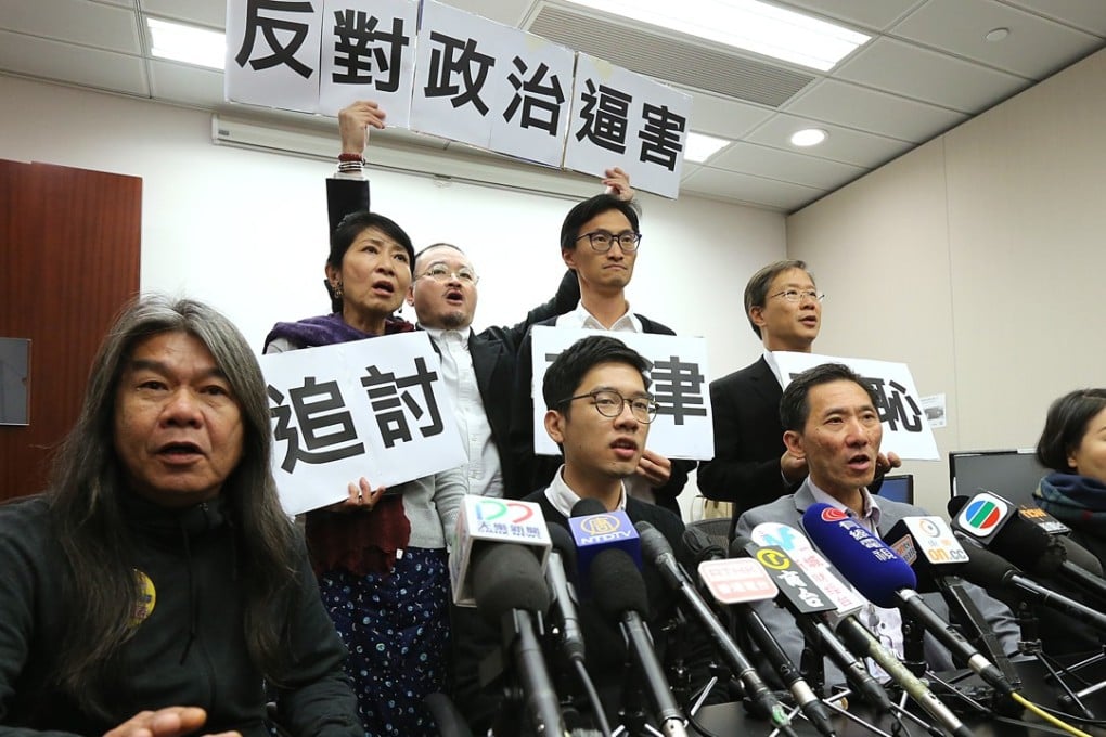 Disqualified legislators (front row, from left) Leung Kwok-hung, Nathan Law, Edward Yiu and Lau Siu-lai attend a press conference at the Legislative Council building in Tamar on November 27. Photo: Felix Wong