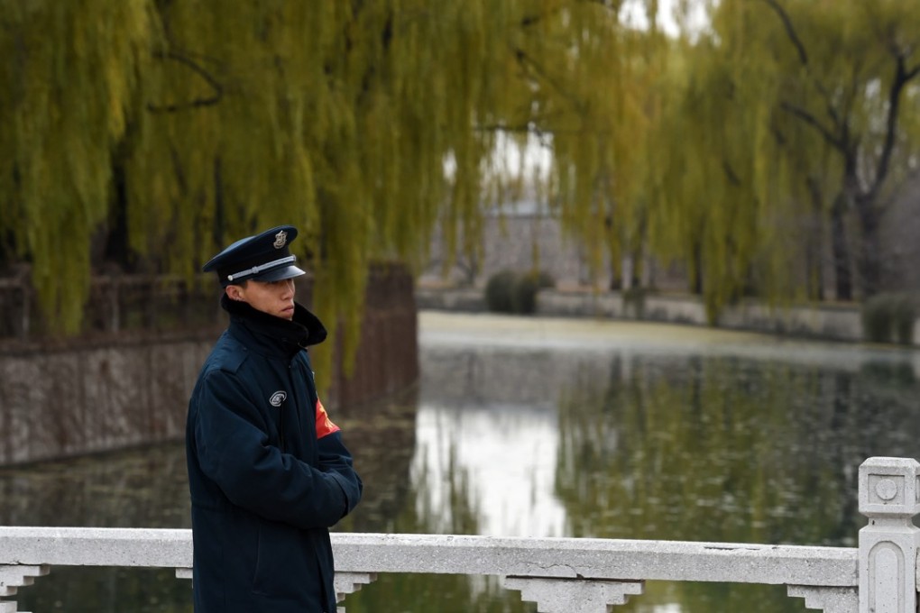 A file picture of a guard standing by a canal leading to a storage reservoir for China’s South-North Water Diversion project. It transfers water from central provinces to more arid areas in the north of the country. Photo: Agence France-Presse