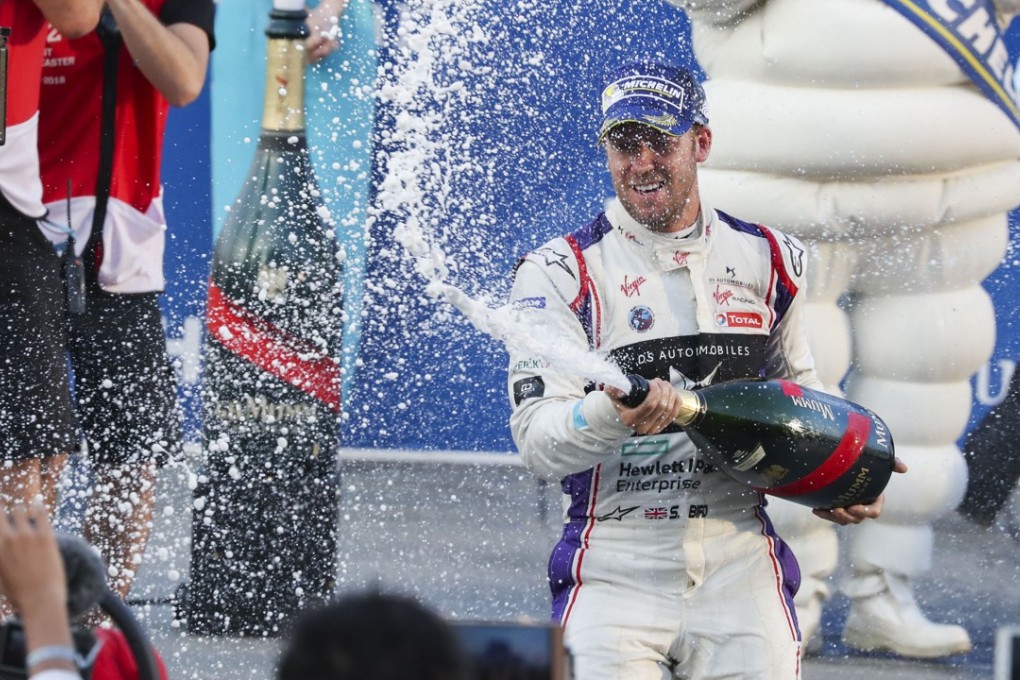 Sam Bird pops open the champagne on the podium. Photo: K.Y. Cheng