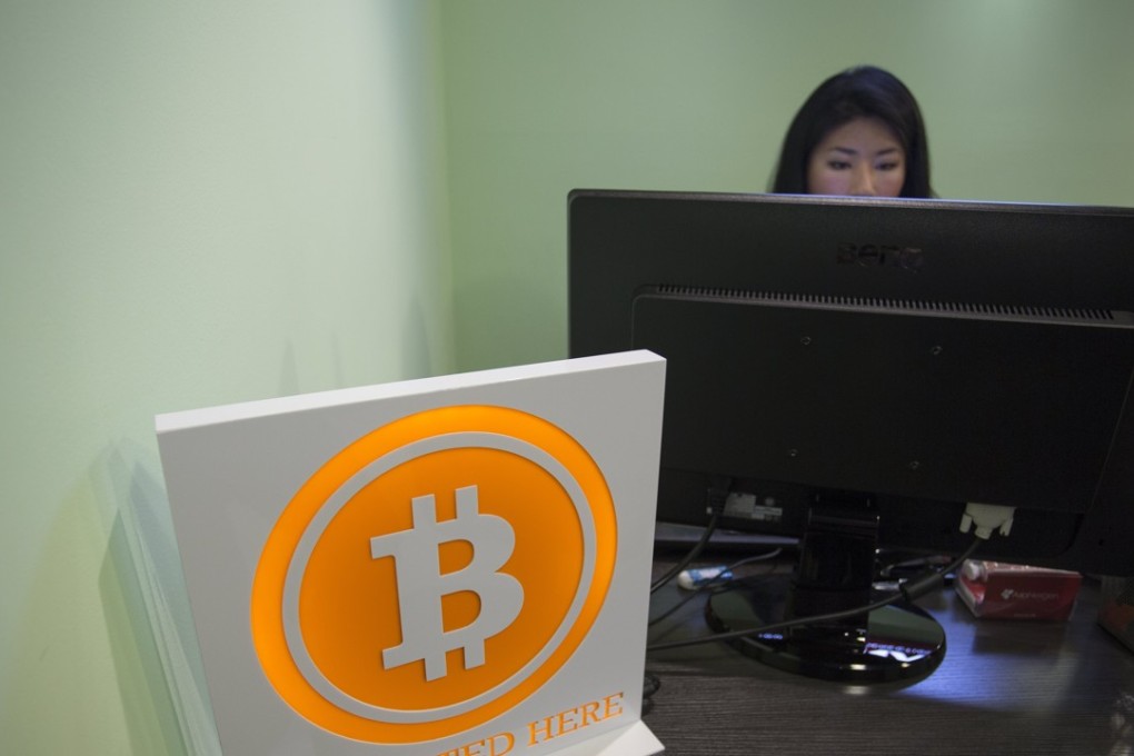 A bitcoin sign is displayed in the lobby of the ANX office headquarters in Hong Kong, China. Two Chicago-based exchanges are launching bitcoin futures in December 2017. Photo: EPA-EFE