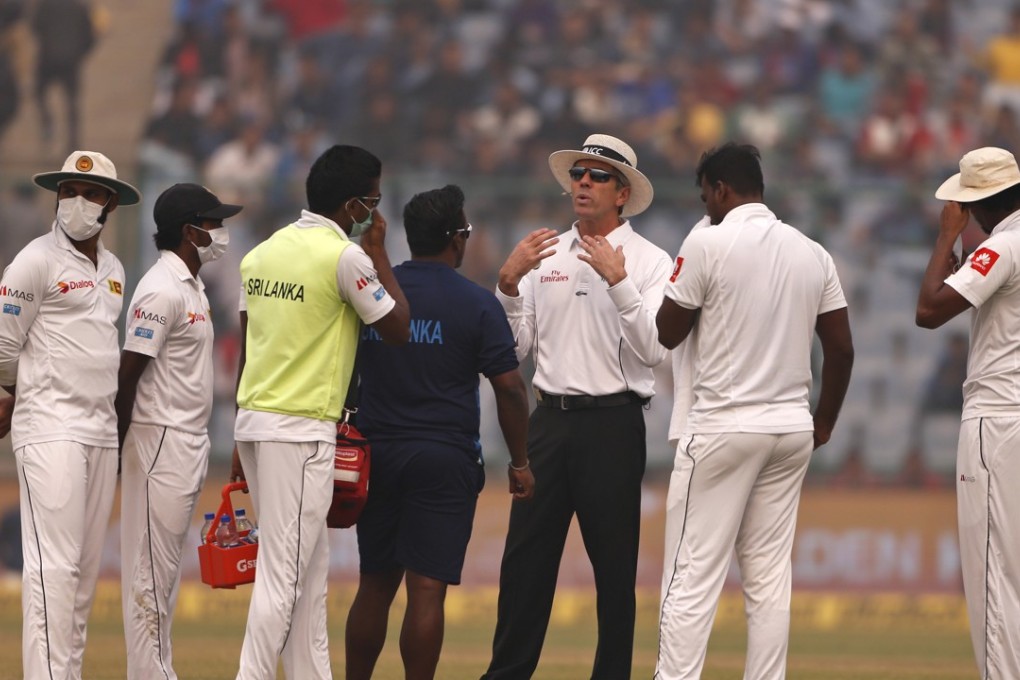 Umpire Nigel Llong, third from right, explained the decision to Sri Lanka players. Photo: AP