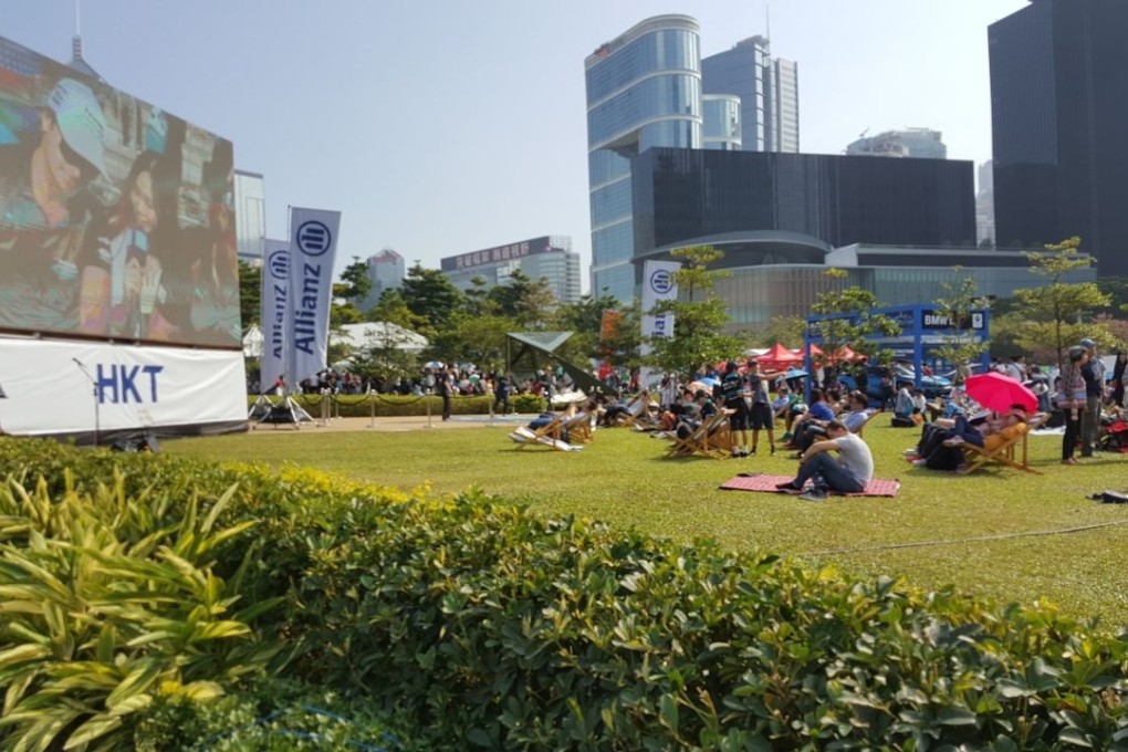 Fans watch the action on the track on the big screen at E-Village. Photos: Unus Alladin