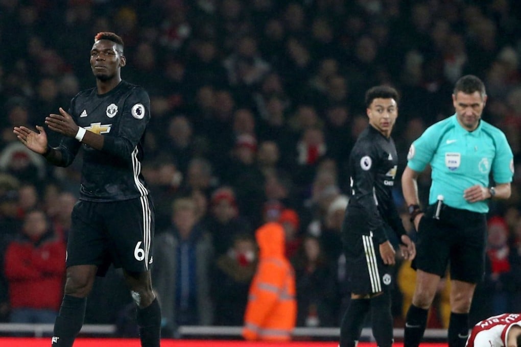Manchester United’s Paul Pogba sarcastically applauds the referee after his dismissal. Photo: EPA