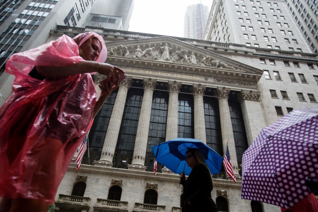 Pedestrians walk past the New York Stock Exchange (NYSE) in New York, US. Photo: Bloomberg