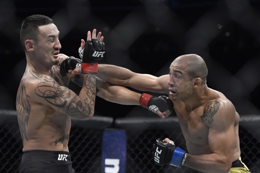 Max Holloway (L) is hit by Jose Aldo during the first round of their UFC 218 featherweight title bout. Photo: AP