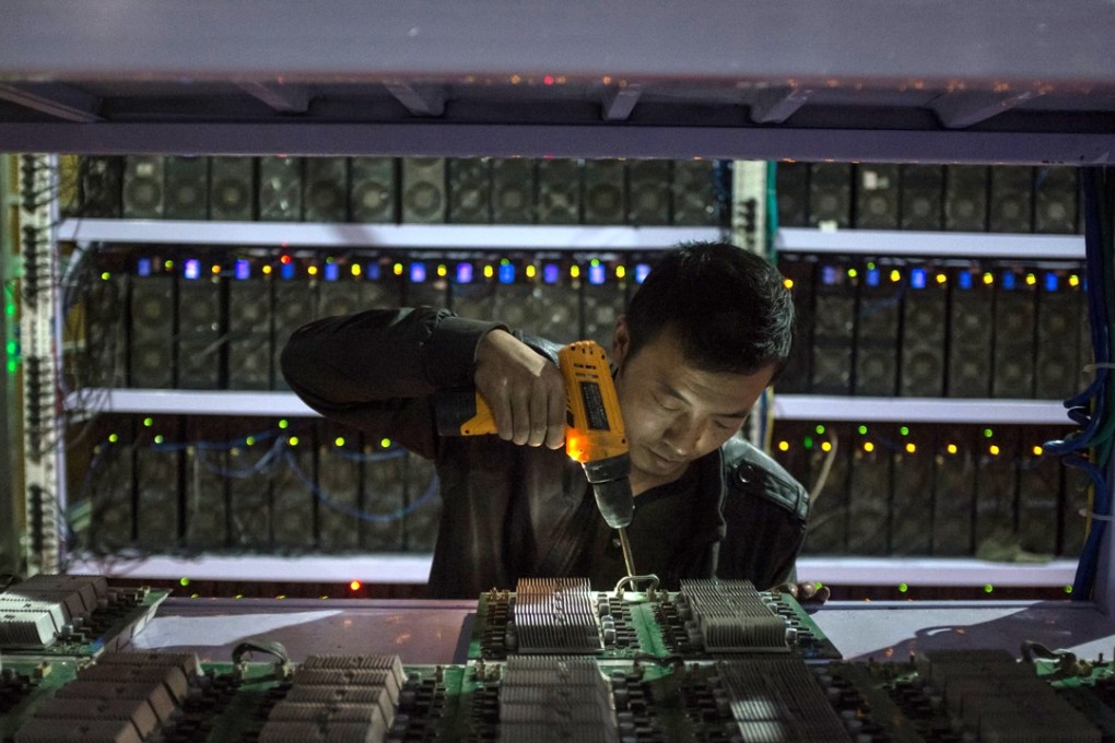 An employee resembles a calculation board at a bitcoin mine in Sichuan Province. Sichuan has become known as 'the capital of bitcoin mining' as entrepreneurial Chinese set up 'mines' there due to its abundance of hydropower, perfect for the high electricity needs of the large number of computers required for bitcoin mining. Photo: EPA