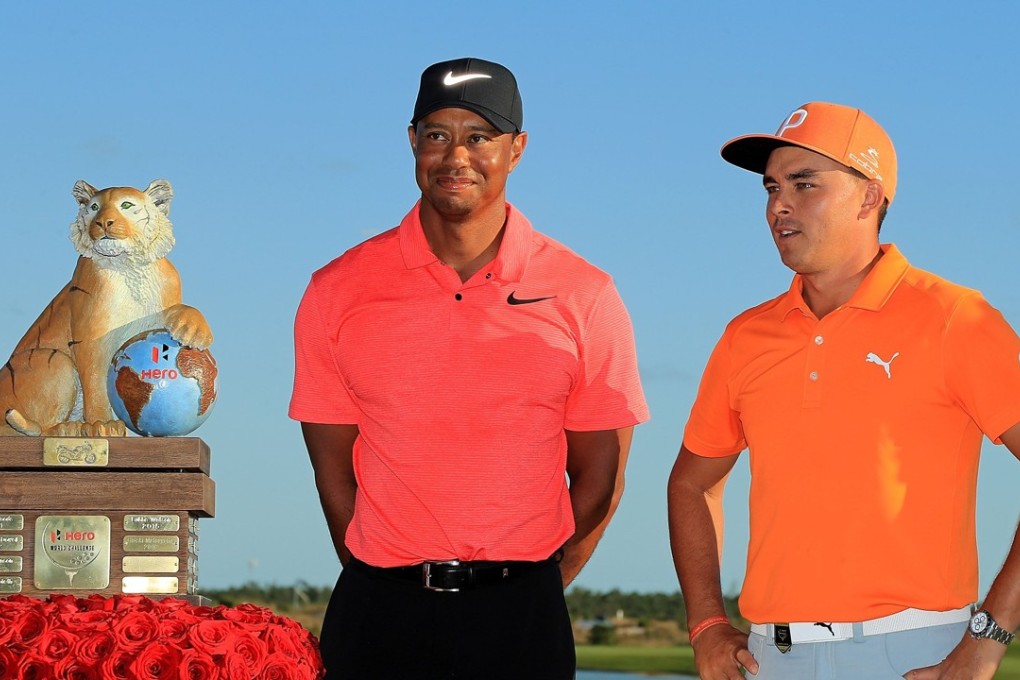 Rickie Fowler poses with tournament host Tiger Woods after winning the Hero World Challenge in the Bahamas. Photo: AFP