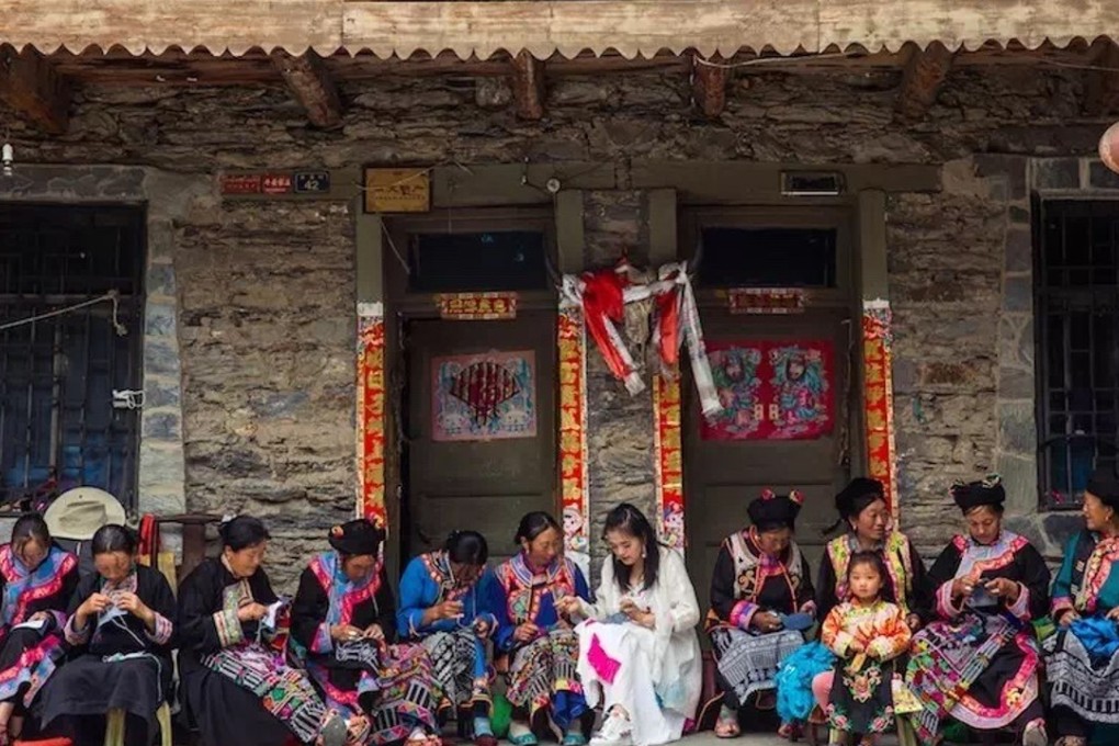 Zhang Juyue (centre) embroiders with women from Xiuxi village in Li county, Aba prefecture, Sichuan. Photo: Handout