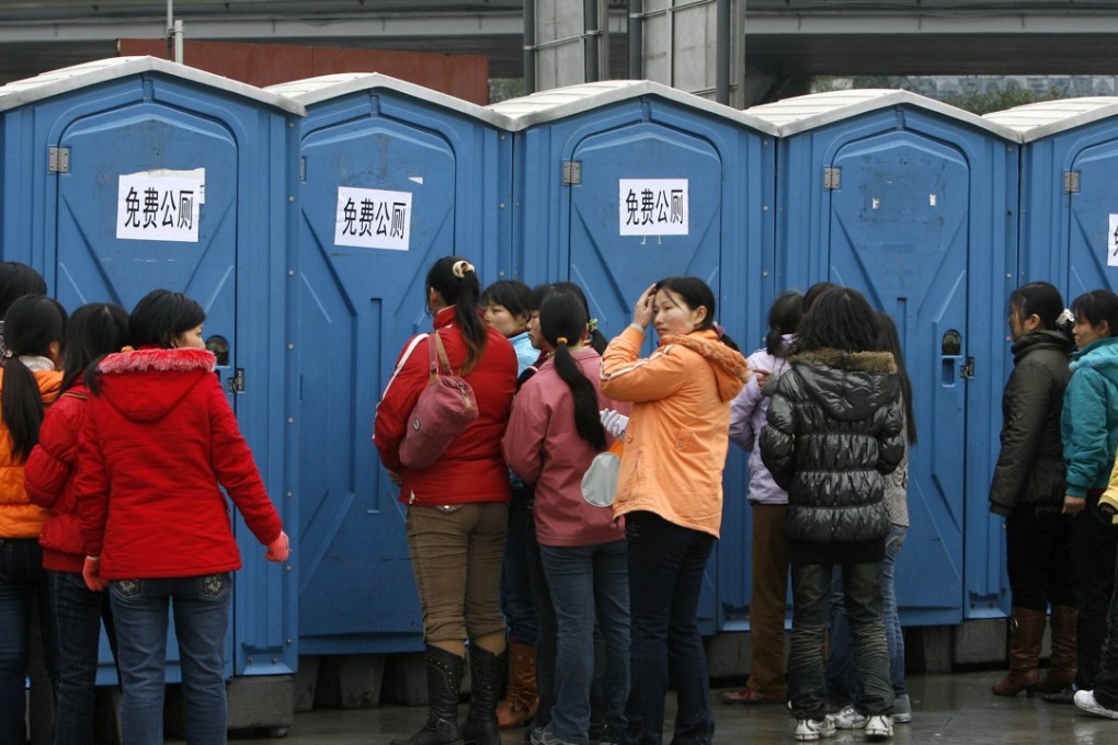 Female passengers line up at the public toilets in Guangzhou. Photo: AFP