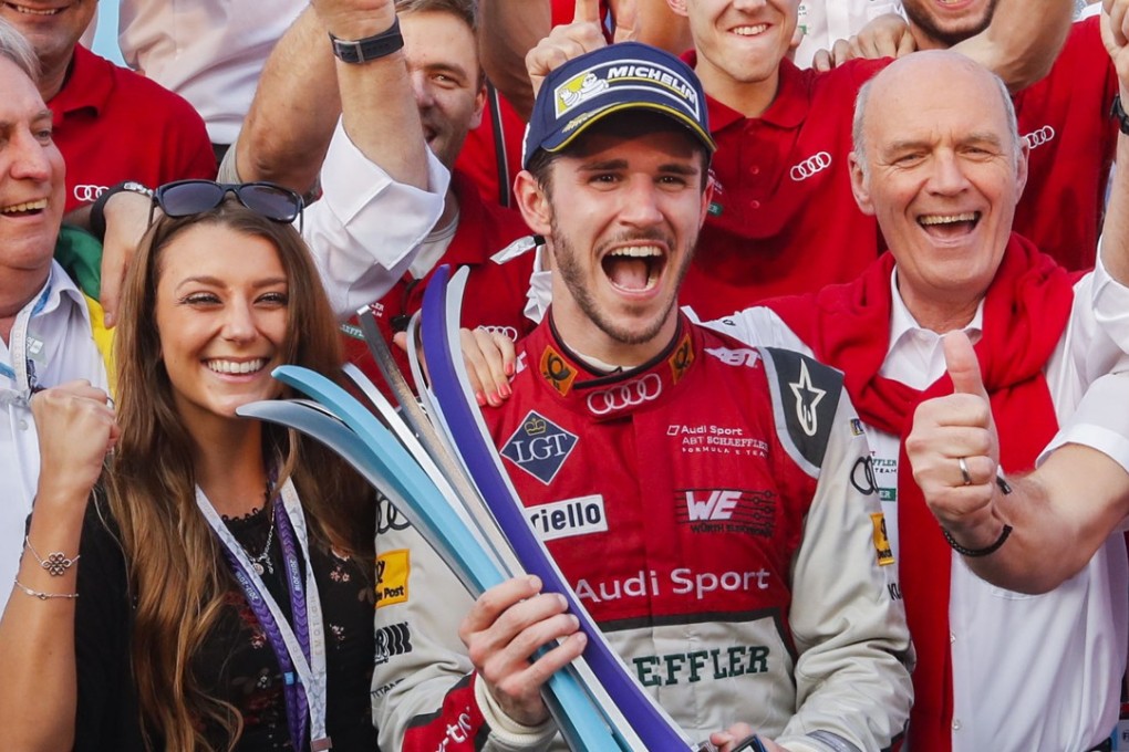 Daniel Abt (centre) holds the HKT Hong Kong E-Prix trophy as he celebrates with his Audi Sport ABT Shaeffler team. Photo: Edward Wong