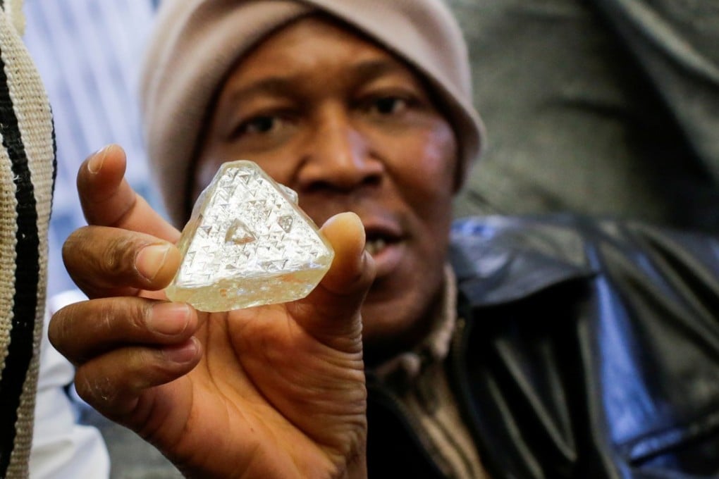 Dennis Kabatto, from Sierra Leone, holds the 709-carat diamond. Photo: Reuters