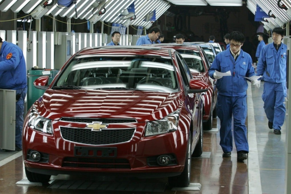 Workers build Chevrolet Lova cars on a General Motors production line in Shenyang. Photo: EPA