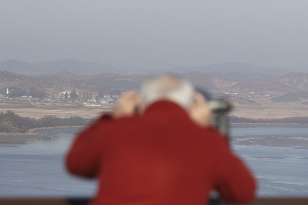 A man looks at North Korea through binoculars from the unification observatory in Paju, South Korea, on November 14. Russia is proposing a three-phase road map for peace, supported by the Chinese. Photo: AP