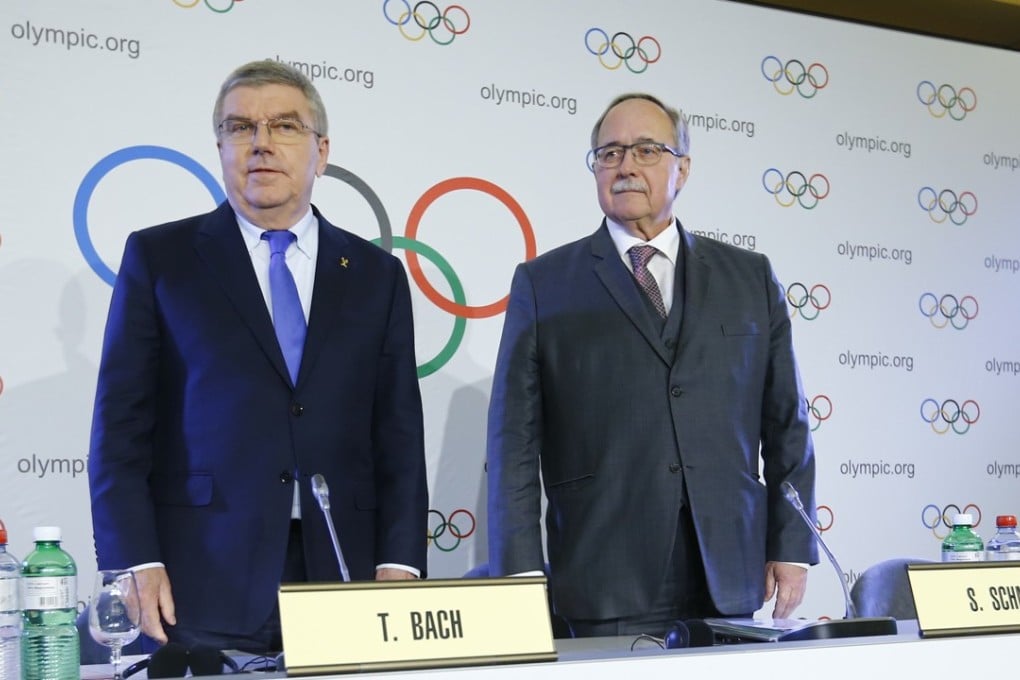 Samuel Schmid, chair of the IOC disciplinary commission, and Thomas Bach, president of the International Olympic Committee, announcing Russia’s ban at a news conference. Photo: Reuters